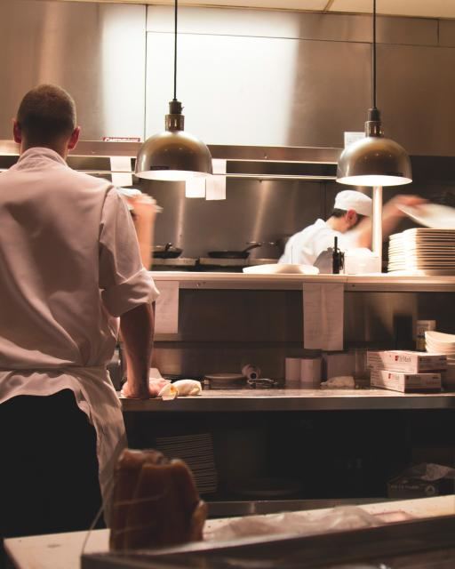 A chef preparing dishes in a restaurant kitchen